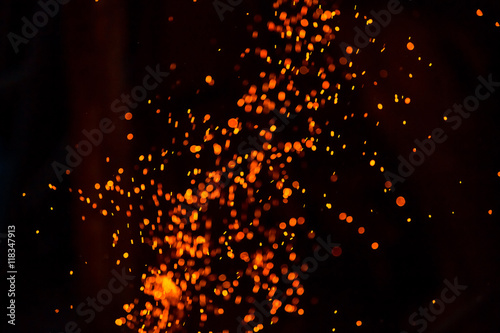 Christmas Glitter Lights Defocused Background. Sparks from the flame