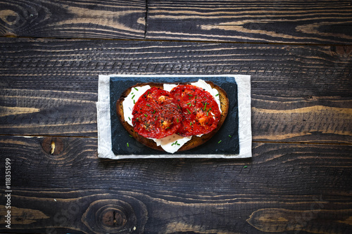 Veggie Food composition with half avocado over a darkdish photo