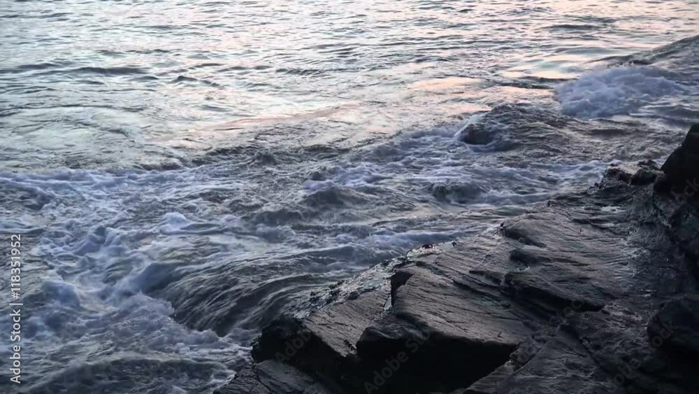 Powerful waves washing over dangerous rocks close up slow motion. Powerful waves washing over dangerous rocks close up slow motion.