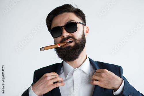 Foto Businessman savoring success with a cigar - isolated