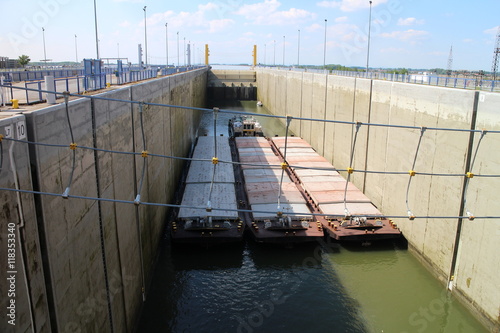 Tug boat with three boats in lock chamber of Gabčíkovo, Slovakia photo