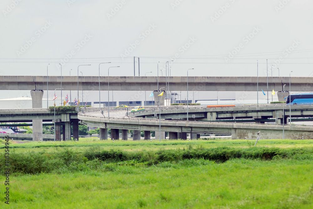 Highway or elevated expressway with a grass foreground in Bangkok Thailand.