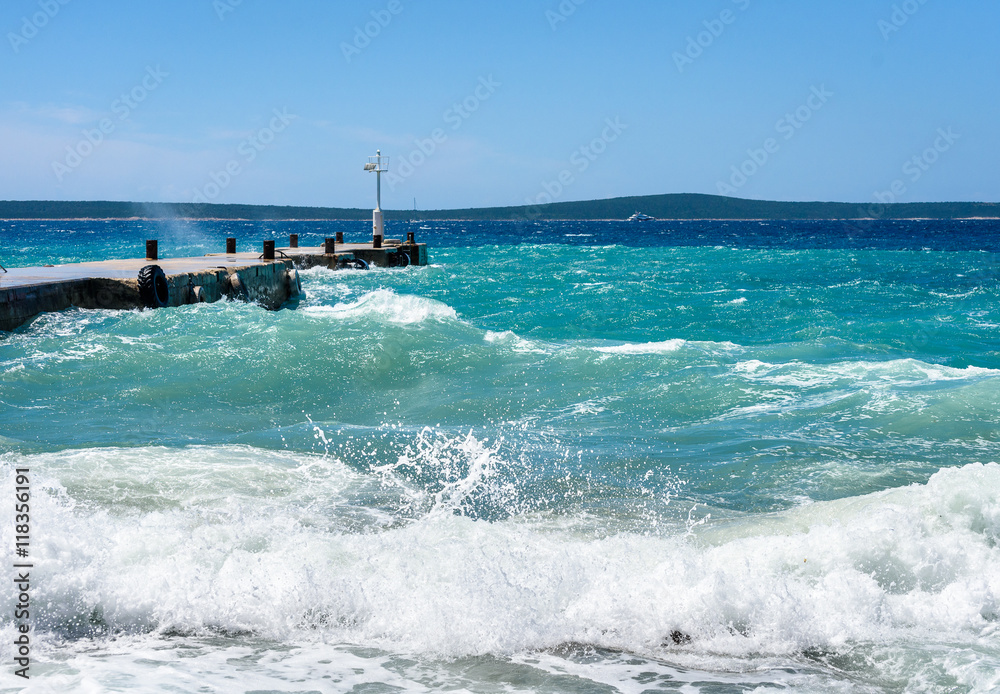 Strong winds and waves are hitting a pier in harbor. Port in Sil Strong winds and waves are hitting a pier in harbor. Port in Sil