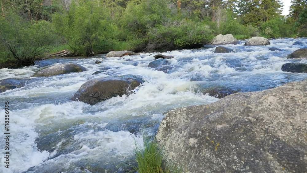 Wide slow motion panning shot of a beautiful rushing fresh water river in Rocky Mountain National Park, Colorado.
Wide slow motion panning shot of a beautiful rushing fresh water river in Rocky Mountain National Park, Colorado.