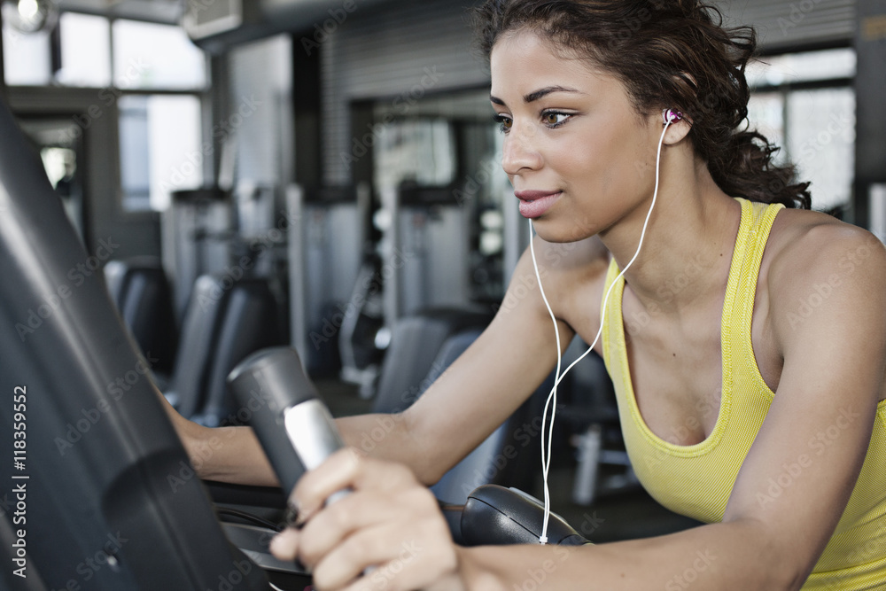 Mixed race woman exercising in health club Mixed race woman exercising in health club