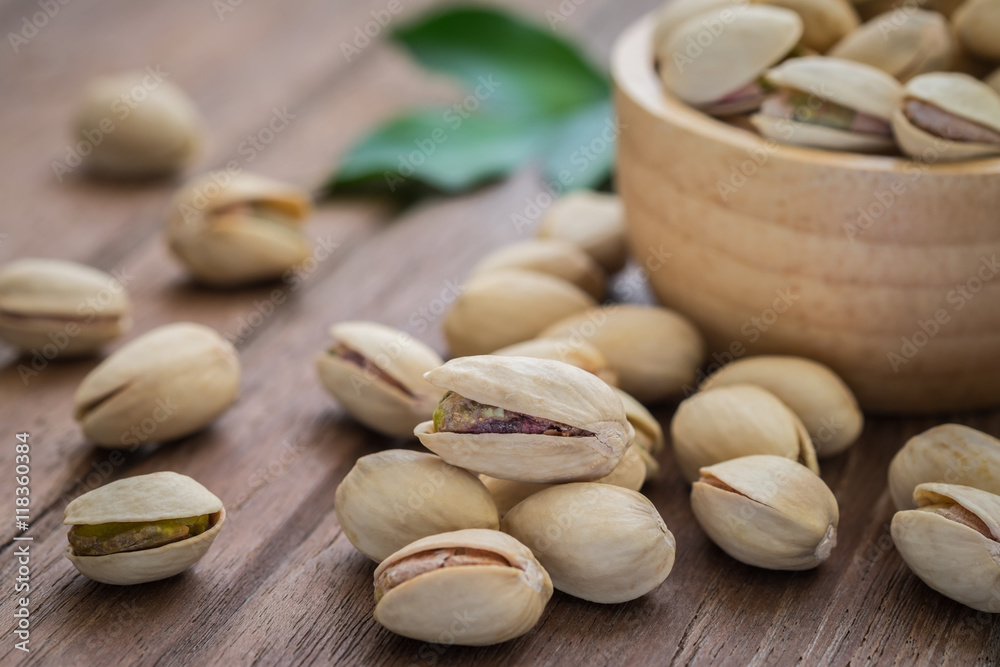 Pistachios on wooden table Pistachios on wooden table