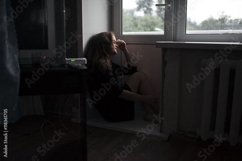 Caucasian woman sitting near door