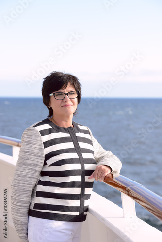 Adult woman standing on ship deck