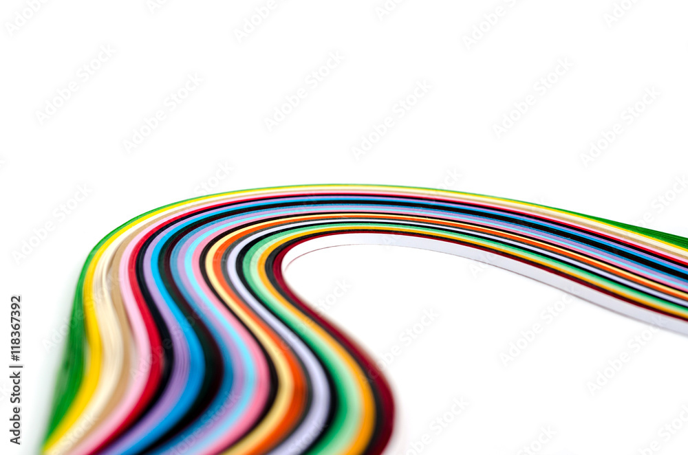 Colorful paper filigree strips in waves on white background Colorful paper filigree strips in waves on white background