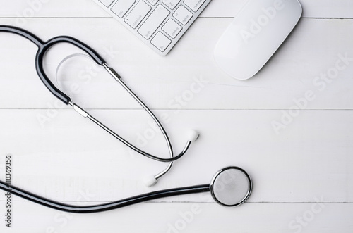 Top view of white wooden working table with computer keyboard, c