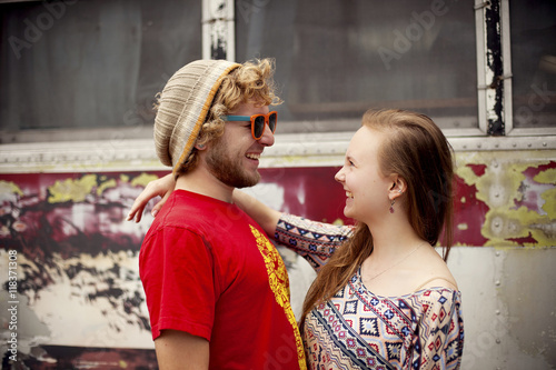 Couple hugging near dilapidated bus photo