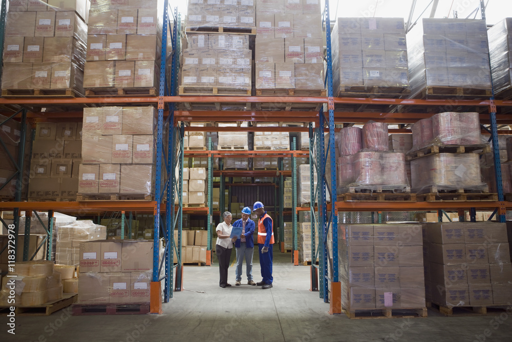 Workers talking in warehouse Workers talking in warehouse