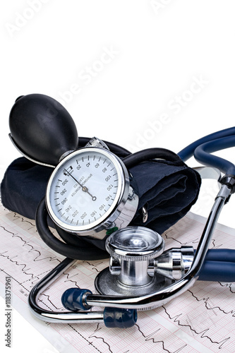 Medical stethoscope and manometer on cardiogram chart isolated closeup