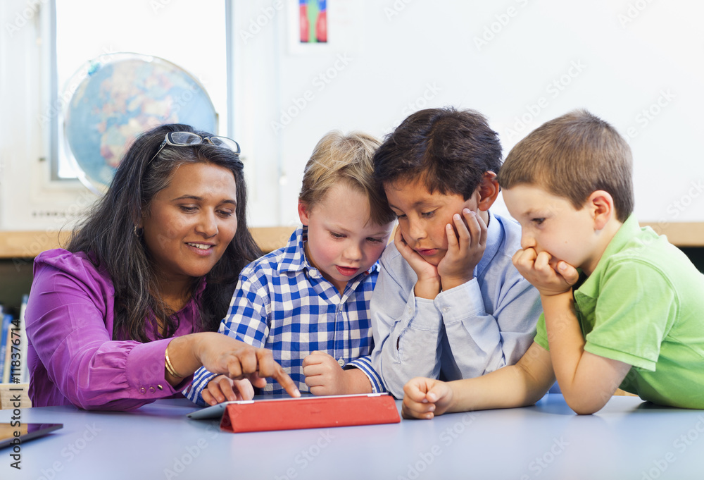 Teacher and students using digital tablet Teacher and students using digital tablet