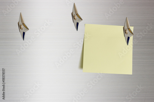 Blank piece of paper attached on a glossy aluminum surface with Japanese ninja concealed weapons. Copy space for leaving several messages i.e. general information, advance information.