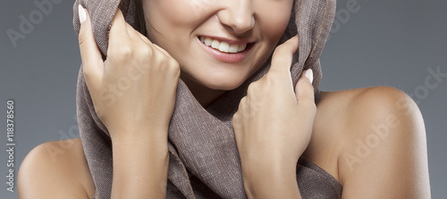 Tableau sur toile Close-up lips, hands and shoulders of smiling woman wearing shawl