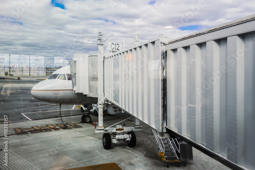 Walkway to airplane on runway photo