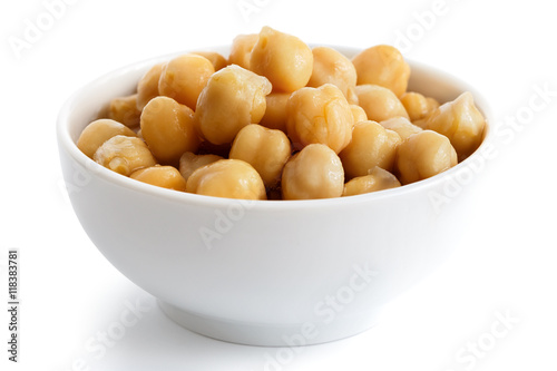 Cooked chickpeas in white bowl isolated on white. photo