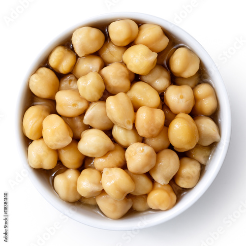 Cooked chickpeas in white bowl isolated on white from above.