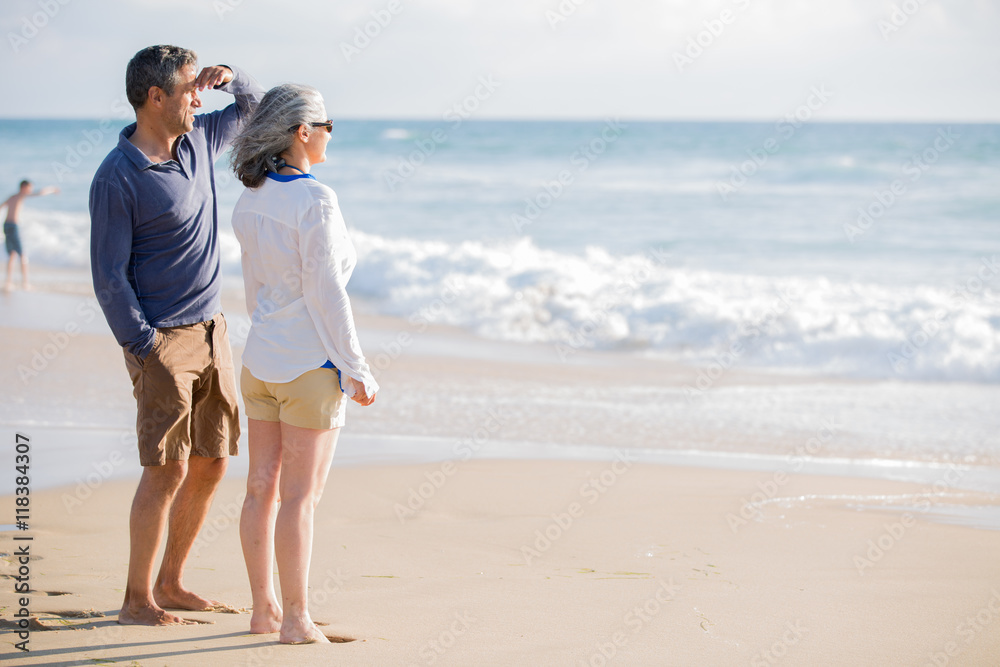 Fototapeta premium mid aged couple laying out on the beach