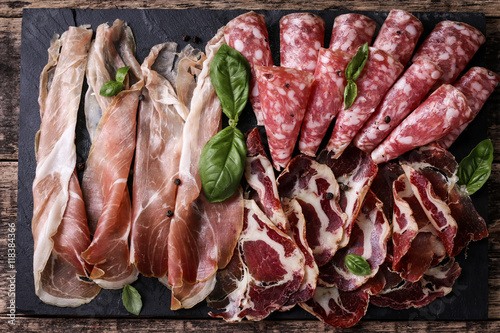 Traditional spanish tapas or italian antipasti on wooden vintage table