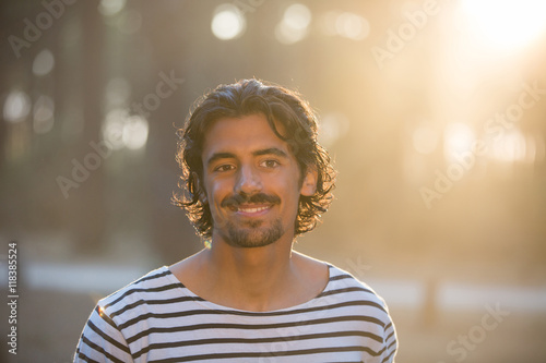 Portrait of young man sunset, flare