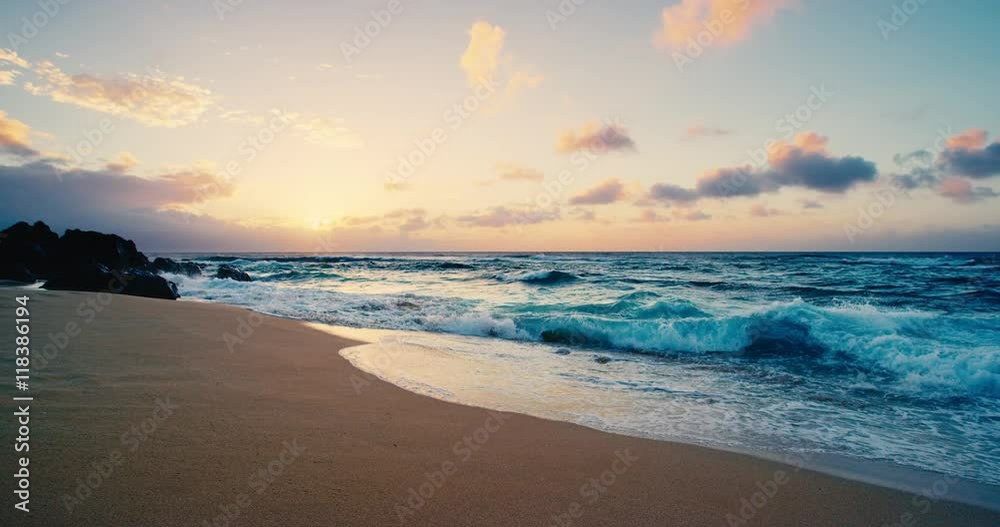 Beautiful beach at sunset with slow motion breaking waves Beautiful beach at sunset with slow motion breaking waves