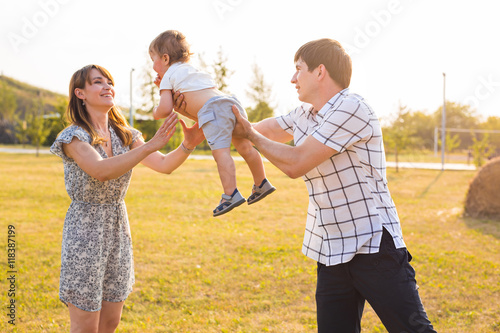 Happy young family having fun outside in summer nature