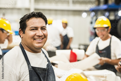 Worker smiling in manufacturing plant