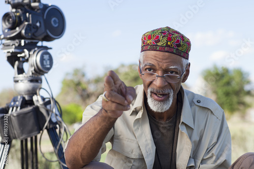 African American director near film camera photo