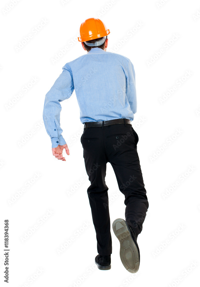 Back view of running engineer in helmet. Walking guy in motion. Rear view people collection. Backside view of person. Isolated over white background. Businessman in a blue shirt and a helmet in a Back view of running engineer in helmet. Walking guy in motion. Rear view people collection. Backside view of person. Isolated over white background. Businessman in a blue shirt and a helmet in a