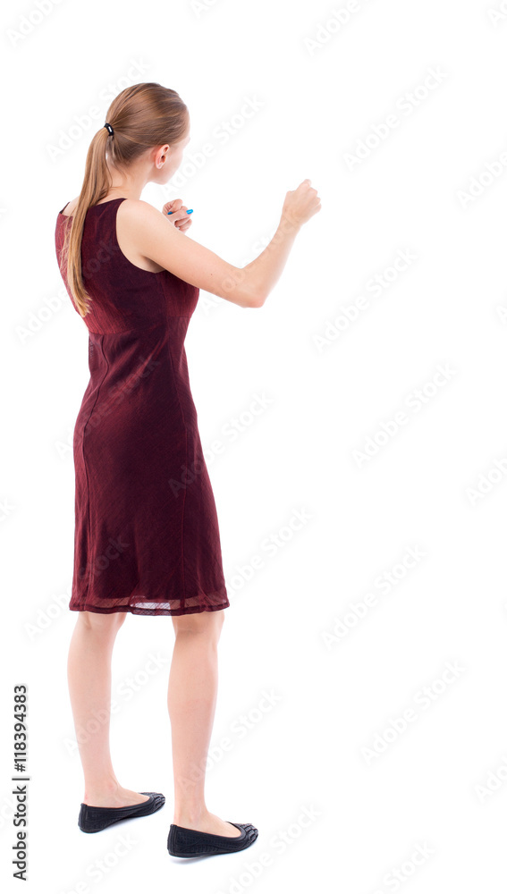 Fototapeta premium skinny woman funny fights waving his arms and legs. Isolated over white background. A girl in a burgundy dress sleeveless boxing.