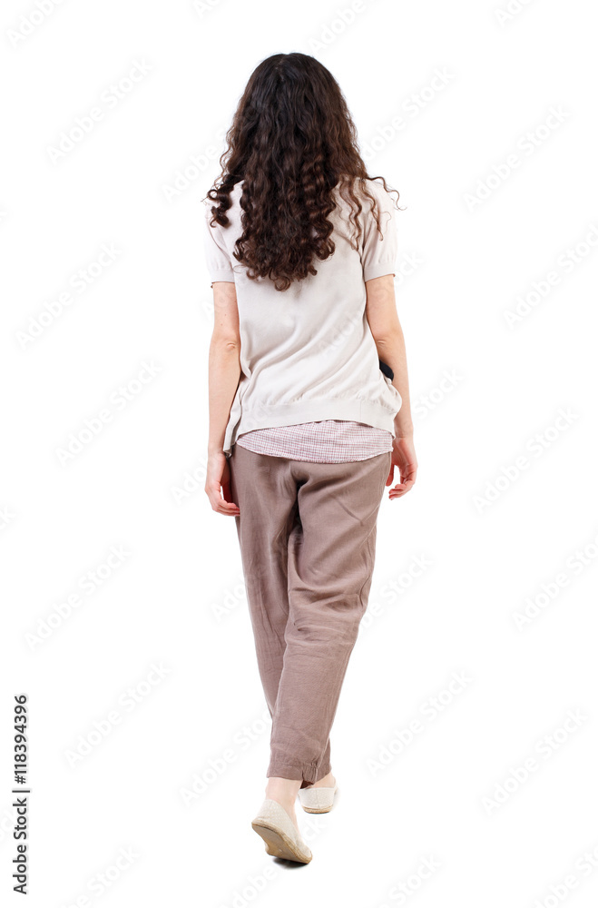 back view of walking curly woman. backside view of person. Rear view people collection. Isolated over white background. Long-haired curly girl goes down hands down. back view of walking curly woman. backside view of person. Rear view people collection. Isolated over white background. Long-haired curly girl goes down hands down.