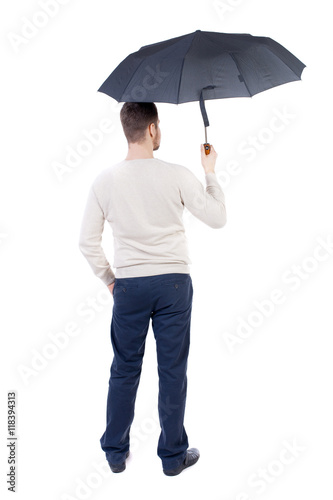 young man in in a white knit sweater under an umbrella. Rear view people collection.  backside view of person.  Isolated over white background. The bearded man in a white warm sweater standing under © ghoststone
