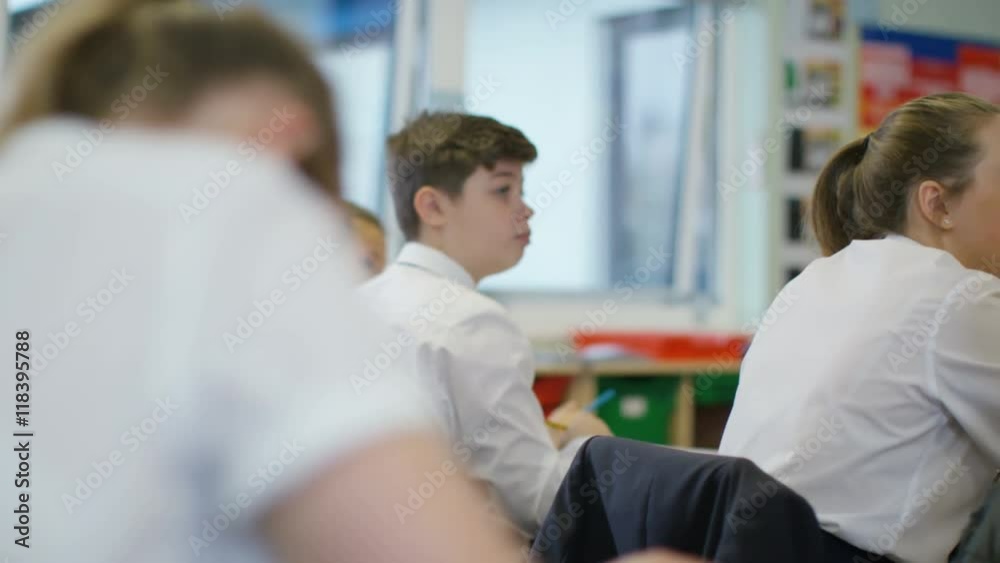  Young students working at their desks in school classroom