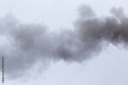 Smoke from a pipe on a cloudy sky