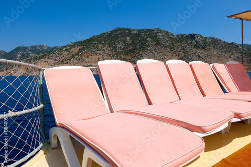 Pink sun beds on a boat in the sea