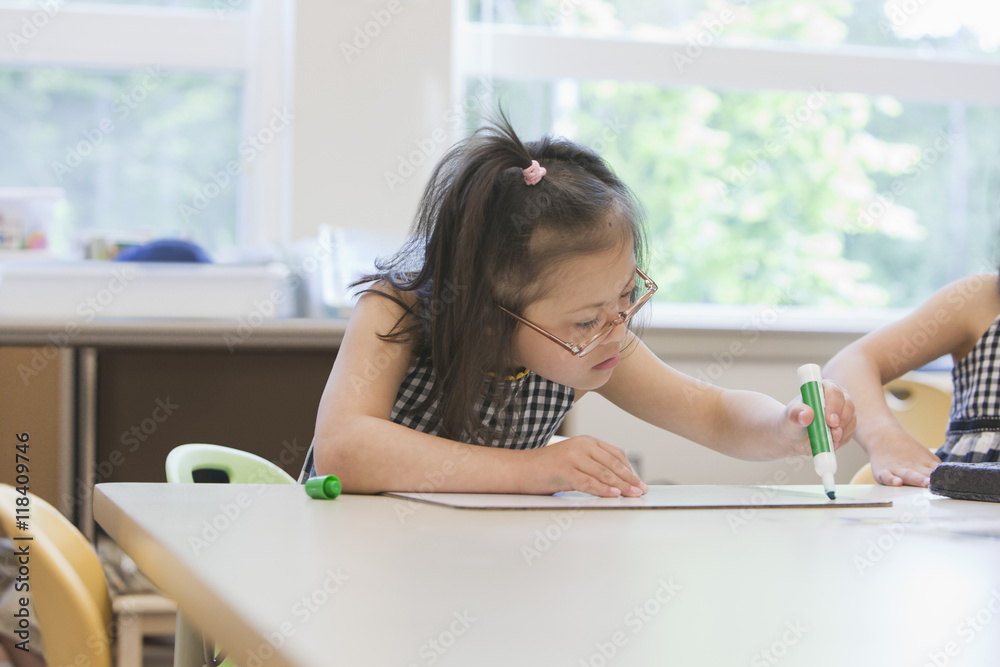 Mixed race Down syndrome students drawing in class Stock Photo Adobe