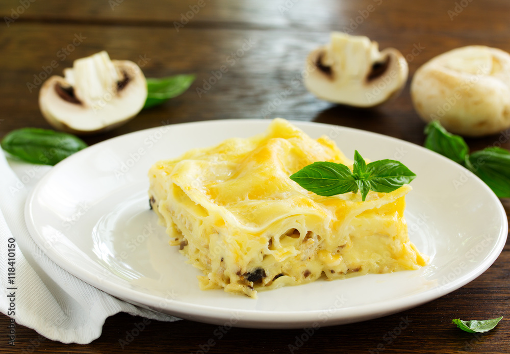 A piece of lasagna with chicken and mushrooms. A piece of lasagna with chicken and mushrooms.