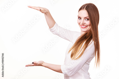 Woman uses hands to indicate area of frame, copy space for product