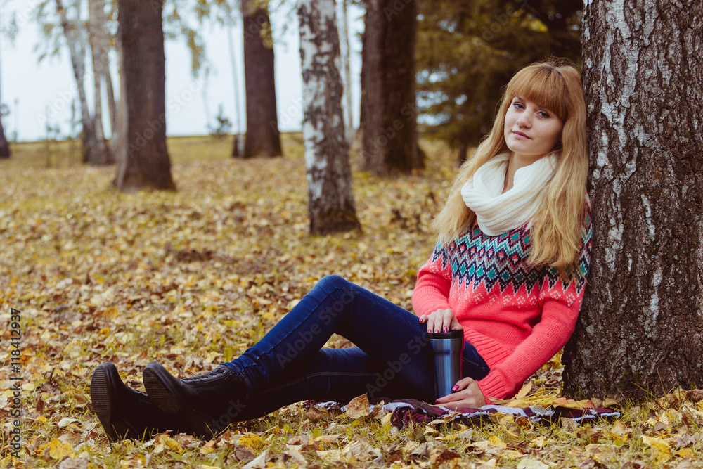 Fall concept - autumn woman drinking coffee in park Fall concept - autumn woman drinking coffee in park