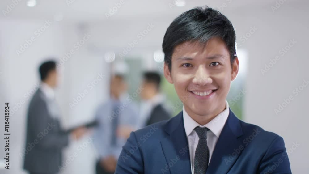 Portrait of smiling Asian businessman in office Portrait of smiling Asian businessman in office