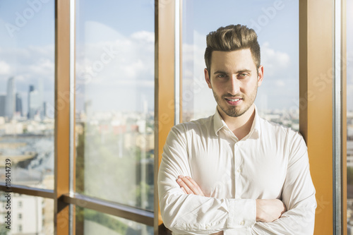 Young man against window
