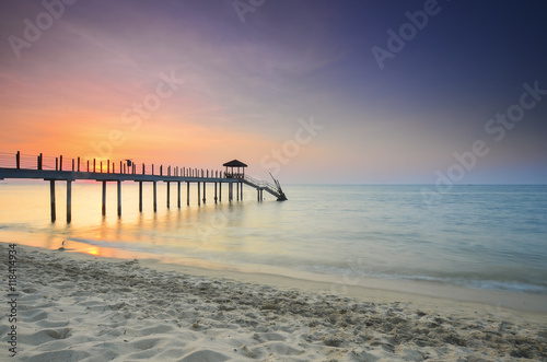 Long exposure of long fisherman jetty during sunset.