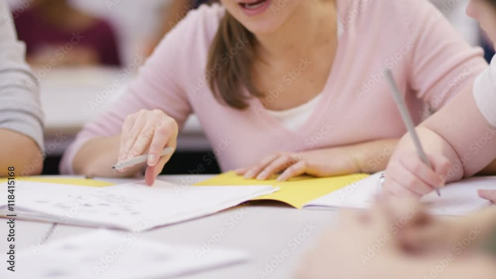Teacher working with young pupils in school lesson Teacher working with young pupils in school lesson