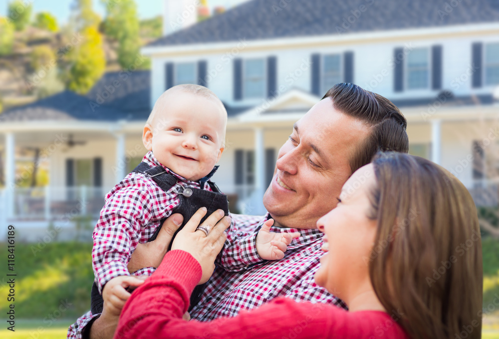 Fototapeta premium Adorable Little Baby Boy Having Fun With Mother and Father In Front Yard Of House.