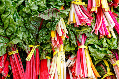 Closeup detail of colorful organic chart at an outdoor farmers market in Seattle.