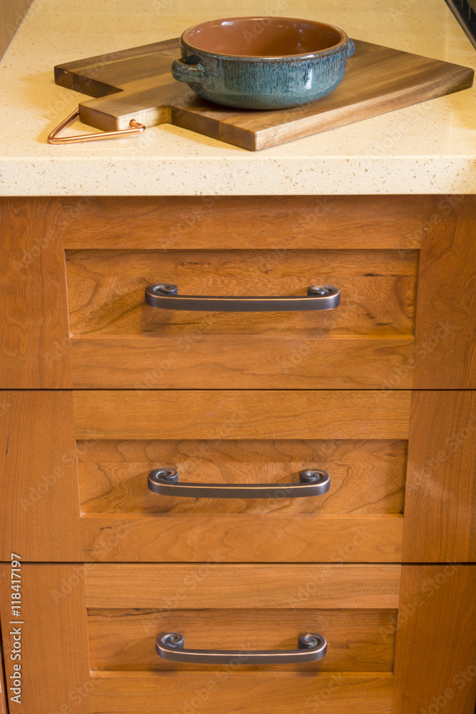 Close-up detail of high quality cherry wood cabinets with bronze cabinet  hardware drawer pulls & quartz countertops in contemporary upscale home  kitchen interior Stock Photo | Adobe Stock