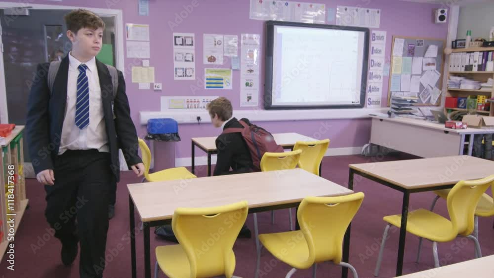  Young students entering school classroom before a lesson.
