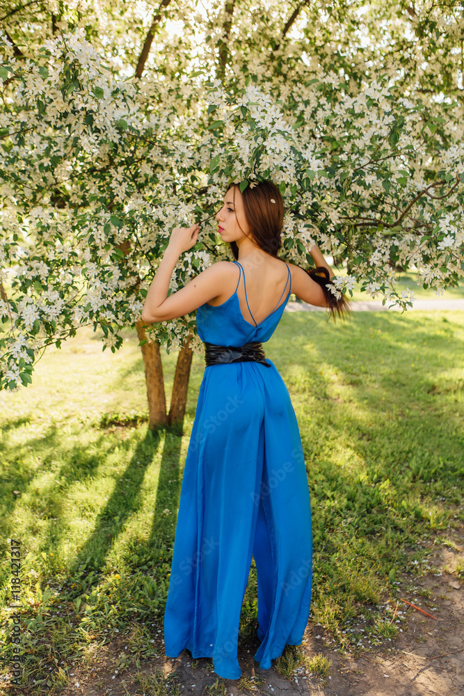 Beautiful young woman standing near the apple tree. Beautiful young woman standing near the apple tree.